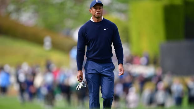 Tiger Woods walks down a fairway while playing a round at Riviera.